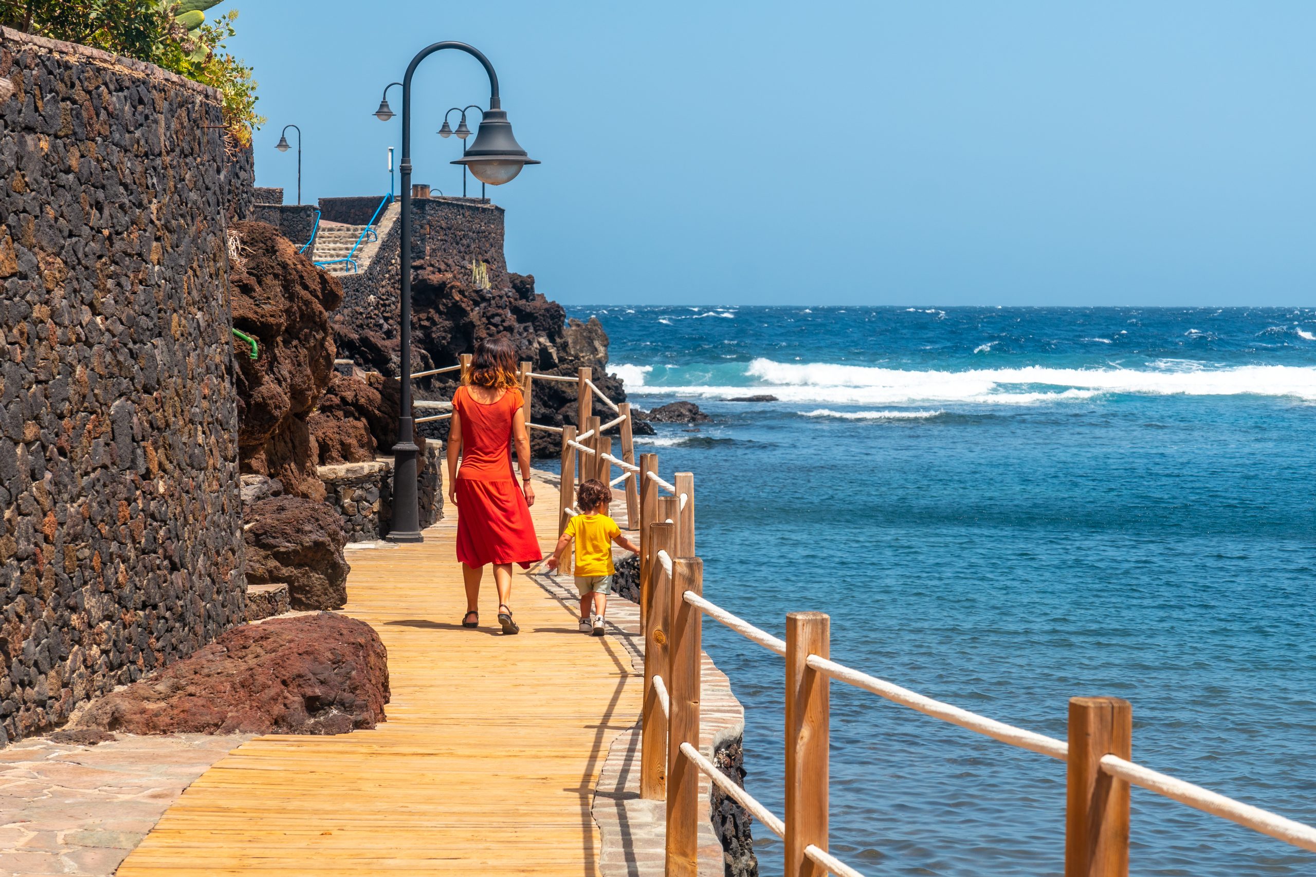 A mother and son on holiday in the seaside tourist village of Tamaduste on the island of El Hierro, Canary Islands, Spain